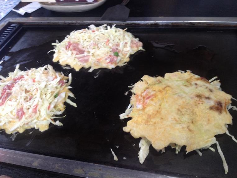 Preparación de okonomiyaki en un restaurante japonés